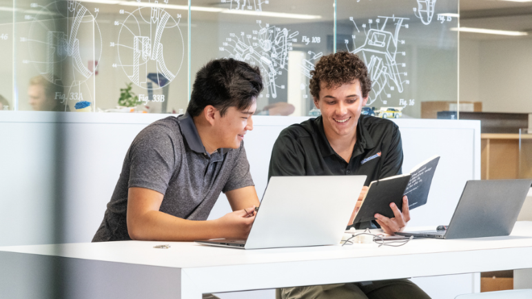 two interns at computer