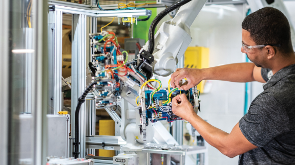 person working on industrial automation robot