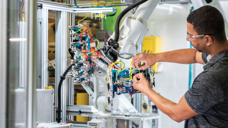 person working on industrial automation robot